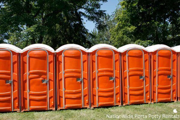 a lineup of clean and well-maintained portable loos for workers in Penfield, NY